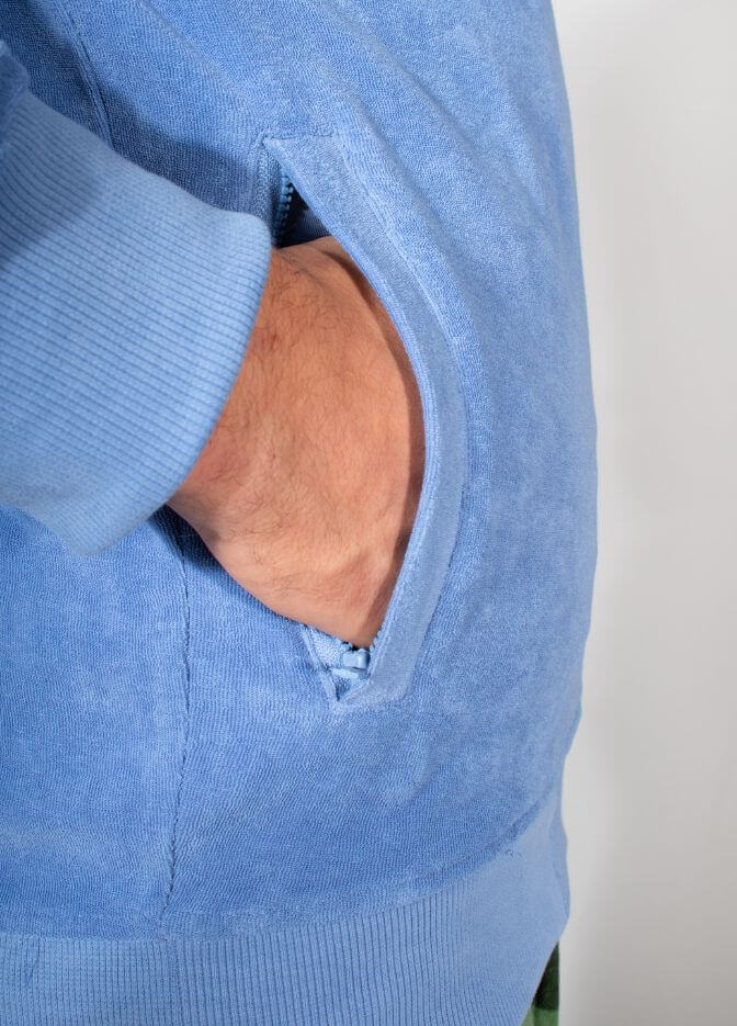 guy wearing nuffinz towel jacket lily pad blue side pocket closeup